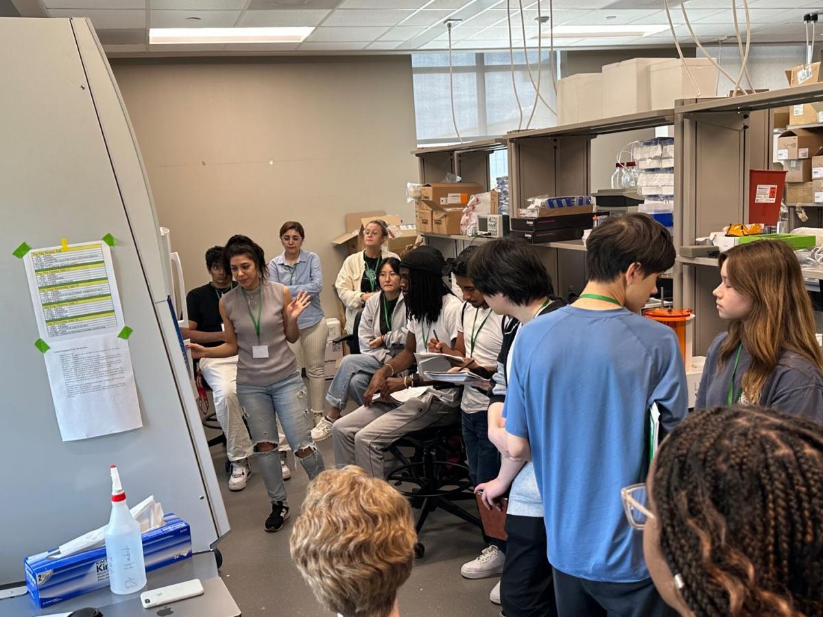 Dr. Habibi with a large group of students in lab